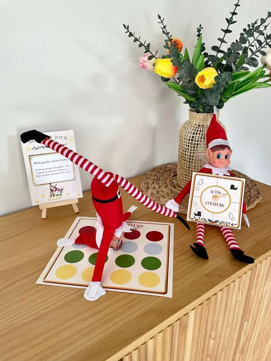 Lutin en équilibre sur un tapis de pastilles colorées pendant qu'un autre tient la roue des couleurs